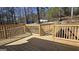 New wooden deck with railings overlooking the property and cars parked nearby at 3189 Fern Ridge Ne Dr, Conyers, GA 30013