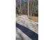 Gravel driveway surrounded by trees leading to a home, blending into the natural landscape at 3189 Fern Ridge Ne Dr, Conyers, GA 30013