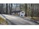 Exterior of home displaying long driveway leading to the house with a welcoming front deck and wooded surroundings at 3189 Fern Ridge Ne Dr, Conyers, GA 30013