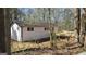 Exterior view showcases the home's side with a wooden deck, surrounded by lush greenery and trees at 3189 Fern Ridge Ne Dr, Conyers, GA 30013