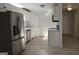 A kitchen featuring stainless steel appliances, modern cabinets, and wood-look floors at 3189 Fern Ridge Ne Dr, Conyers, GA 30013
