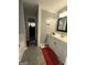 Well-lit bathroom featuring a white vanity, a decorative mirror, and gray granite tile flooring at 133 Ventura Trl, Stockbridge, GA 30281