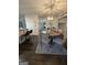 Open dining area with a round table, chairs, and a view to a kitchen bar at 133 Ventura Trl, Stockbridge, GA 30281