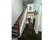 Inviting foyer with hardwood floors, stairs, and an open view into the dining area at 133 Ventura Trl, Stockbridge, GA 30281