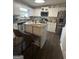 Modern kitchen with stainless steel appliances, granite countertops, and an island with seating at 133 Ventura Trl, Stockbridge, GA 30281