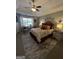 Comfortable main bedroom features a tray ceiling, a sitting area, and stylish decor at 133 Ventura Trl, Stockbridge, GA 30281