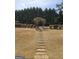 Expansive backyard features a stone walkway and a beautiful trellised gate at 7354 Spoleto Loop, Fairburn, GA 30213