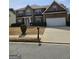 Attractive two-story brick home boasts an attached two-car garage and manicured front lawn at 7354 Spoleto Loop, Fairburn, GA 30213
