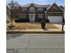 Beautiful two-story brick home with a two-car garage and well-maintained landscaping at 7354 Spoleto Loop, Fairburn, GA 30213