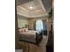 Spacious main bedroom features a tray ceiling, a large window, and neutral decor at 7354 Spoleto Loop, Fairburn, GA 30213