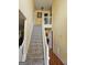 Carpeted staircase with white railing, leading to the upper level of the home at 7354 Spoleto Loop, Fairburn, GA 30213