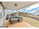 Covered back porch has a large outdoor seating area with a fire pit that overlooks a grassy backyard at 814 Parker Pass, Peachtree City, GA 30269