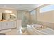 This bathroom has a separate shower and soaking tub, along with double sinks, and a neutral color palette at 814 Parker Pass, Peachtree City, GA 30269