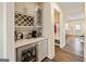 Butler's pantry featuring wine rack, beverage fridge, white countertops, and chevron backsplash at 814 Parker Pass, Peachtree City, GA 30269