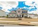 Two story home with brick and stone, black shutters, covered porch, and well-maintained lawn at 814 Parker Pass, Peachtree City, GA 30269