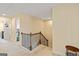 Upstairs hallway with carpeted floors, a wooden railing, and doors leading to bedrooms at 814 Parker Pass, Peachtree City, GA 30269