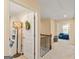 Hallway view featuring carpeted floors, wooden railing, and open doorways at 814 Parker Pass, Peachtree City, GA 30269