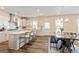 Open kitchen featuring a large island, modern appliances, and adjacent dining area at 814 Parker Pass, Peachtree City, GA 30269