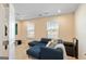 A cozy living room features a comfortable blue sectional sofa and bright windows at 814 Parker Pass, Peachtree City, GA 30269