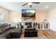 Cozy living room with a stone fireplace, ceiling fan, and a wooden trunk coffee table at 814 Parker Pass, Peachtree City, GA 30269