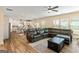 Open-concept living room showcasing a large sectional sofa, kitchen, and wood-style flooring at 814 Parker Pass, Peachtree City, GA 30269