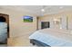 A spacious primary bedroom with a ceiling fan and mounted TV is connected to the en-suite bathroom at 814 Parker Pass, Peachtree City, GA 30269