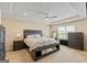 A primary bedroom boasts a tray ceiling, ceiling fan, and large windows for lots of natural light at 814 Parker Pass, Peachtree City, GA 30269