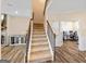 Carpeted staircase leading upstairs, adjacent to the living room and an office at 814 Parker Pass, Peachtree City, GA 30269