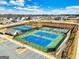 An aerial view of the community's tennis courts, featuring multiple courts and surrounding landscaping at 814 Parker Pass, Peachtree City, GA 30269