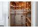 Basement storage area with unfinished walls, exposed piping and wooden shelving at 1491 Hada Ln, Lawrenceville, GA 30044