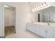 Bright bathroom with a double sink vanity, shower, and walk-in closet at 1491 Hada Ln, Lawrenceville, GA 30044