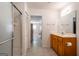 Bathroom with a shower, and a vanity with wood cabinets and a neutral countertop at 1491 Hada Ln, Lawrenceville, GA 30044