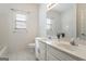 White bathroom with a double sink vanity and tiled floors at 1491 Hada Ln, Lawrenceville, GA 30044