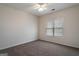 Empty bedroom featuring carpet, ceiling fan, and a window with blinds at 1491 Hada Ln, Lawrenceville, GA 30044