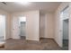 A well-lit bedroom with neutral walls, carpet flooring and an open closet door at 1491 Hada Ln, Lawrenceville, GA 30044