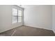 A bright, carpeted bedroom featuring a window with neutral decor at 1491 Hada Ln, Lawrenceville, GA 30044