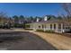 Community clubhouse featuring a covered porch, white columns, and a playground in a well-maintained area at 1491 Hada Ln, Lawrenceville, GA 30044