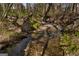 Backyard creek flowing serenely through the landscape, adding natural beauty and tranquility to the property at 1491 Hada Ln, Lawrenceville, GA 30044