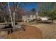 Charming two-story home with beautiful landscaping, complemented by mature trees and a driveway leading to a garage at 1491 Hada Ln, Lawrenceville, GA 30044