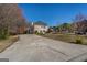 Spacious two-story home with a long driveway and a deck, nestled in a serene landscape with mature trees at 1491 Hada Ln, Lawrenceville, GA 30044