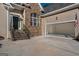 Exterior of a house showcasing a two-car garage with an open door and stone accents around the front entry at 1491 Hada Ln, Lawrenceville, GA 30044