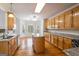 Spacious kitchen with wood cabinets, an island, stainless steel appliances, and hardwood floors at 1491 Hada Ln, Lawrenceville, GA 30044