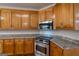 Kitchen featuring granite counters, stainless steel appliances, wood cabinets and an electric cooktop at 1491 Hada Ln, Lawrenceville, GA 30044