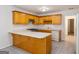 Kitchen with wood cabinets, a center island and neutral countertops and backsplash at 1491 Hada Ln, Lawrenceville, GA 30044