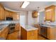Bright kitchen with wood cabinets, stainless steel appliances and granite countertops at 1491 Hada Ln, Lawrenceville, GA 30044