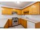 Kitchen featuring wood cabinets, stainless steel appliances, and tile flooring at 1491 Hada Ln, Lawrenceville, GA 30044