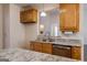 Kitchen with granite countertops, stainless steel sink and wood cabinets at 1491 Hada Ln, Lawrenceville, GA 30044