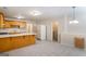 Open kitchen layout with wood cabinets, a center island, and tile flooring at 1491 Hada Ln, Lawrenceville, GA 30044