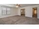 Spacious living room featuring neutral paint, ceiling fan, and an abundance of natural light through the large window at 1491 Hada Ln, Lawrenceville, GA 30044