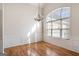 Bright living room with hardwood floors, a chandelier, wainscotting and a large window at 1491 Hada Ln, Lawrenceville, GA 30044